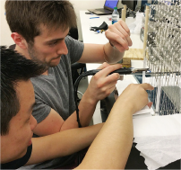 Two team members work on LED Cube.. 