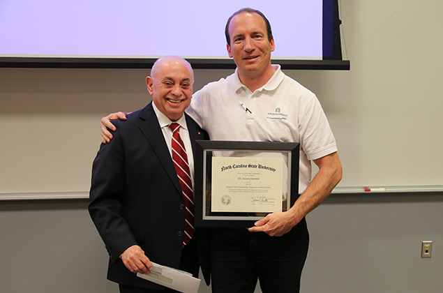Dr. Steven Shannon, right, receives the Blessis award from Dr. Louis A. Martin-Vega.