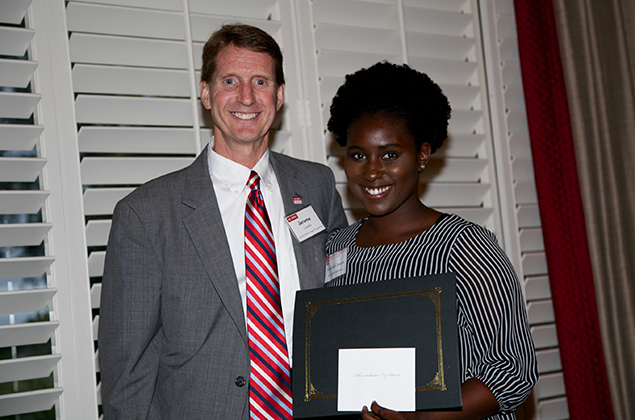 Dr. Jerome Lavelle, associate dean of academic affairs in the College of Engineering, presents the Senior Award for Leadership to Toluwalope Oyelowo, a senior in the Joint UNC/NC State Department of Biomedical Engineering.