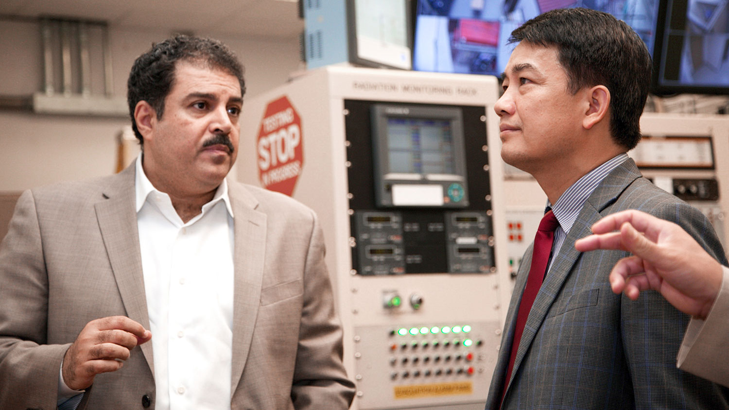 Dr. Ayman Hawari, left, director of NC State's Nuclear Reactor Program, provides Dr. Tran Chi Thanh, president of the Vietnam Atomic Energy Institute, with a tour of the PULSTAR reactor on NC State's campus.