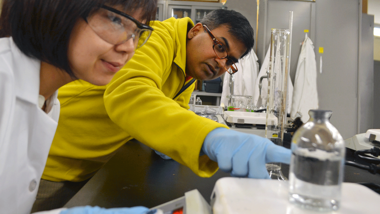 Dr. Praveen Kolar explains to doctoral student Yiying Zhu selective adsorption of p-cresol on biochar.