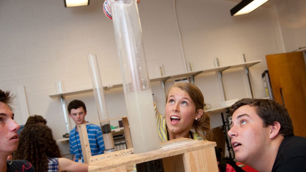 High school campers conduct water filtration test.