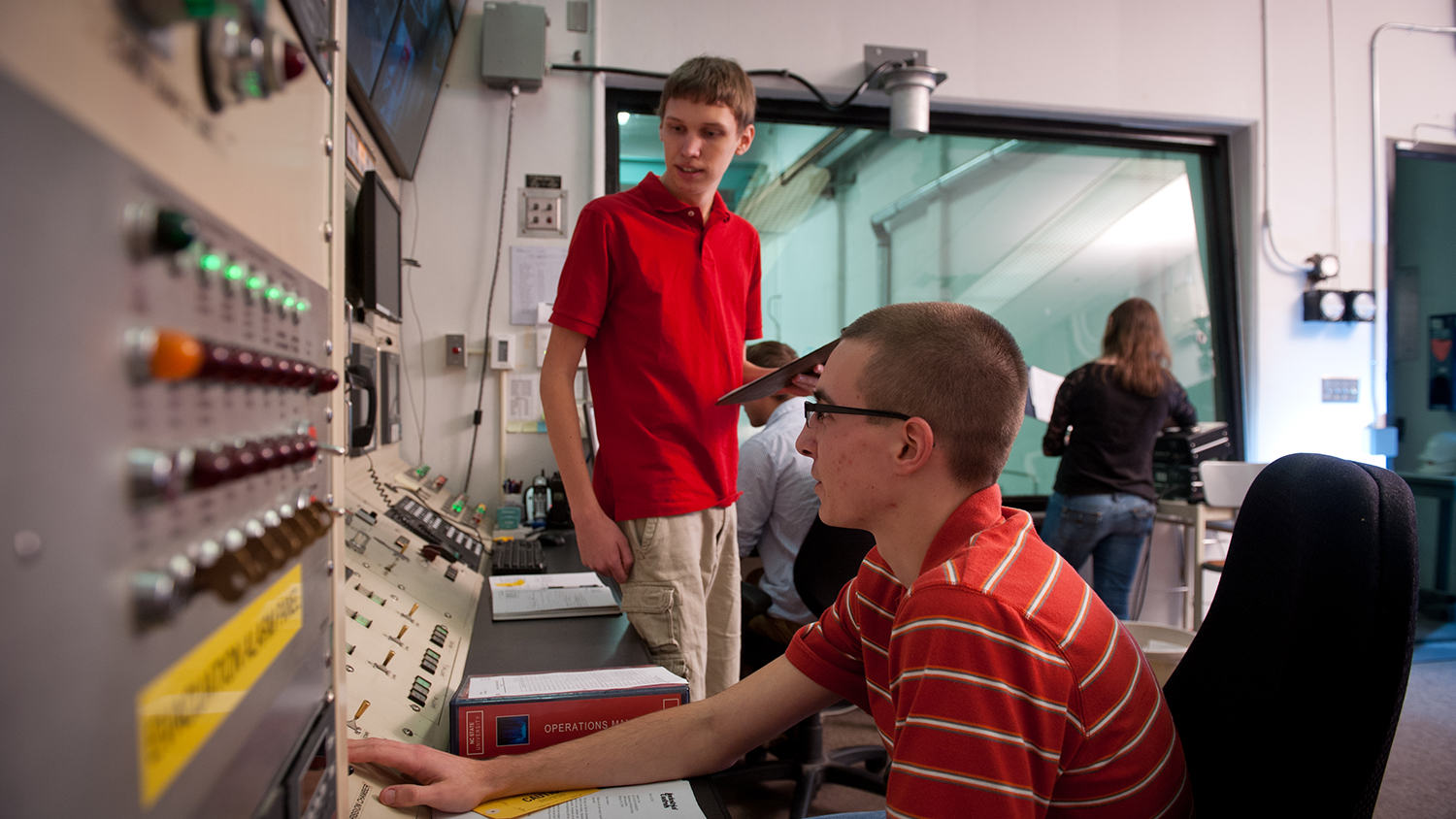 Students in reactor control booth.