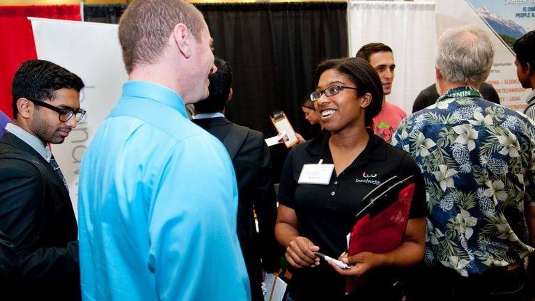 Student chats with employer at the Career Fair.