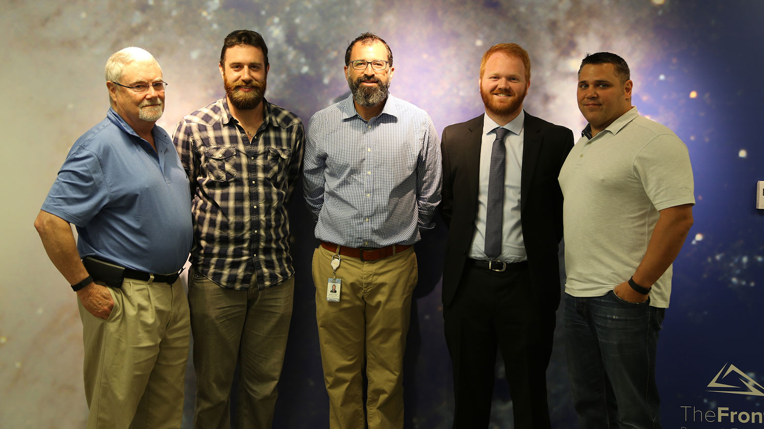 Dr. Andrew DiMeo, third from left, and Andy Taylor, fourth from left, during a Catalysts for Innovation grant announcement.