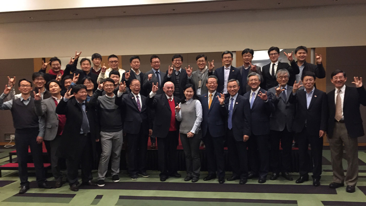 Participants in College of Engineering’s first alumni event held in South Korea show wolf hands.