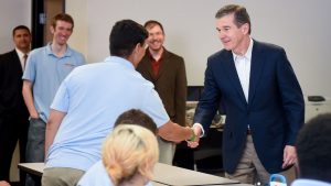 Gov. Roy Cooper is greeted by members of the Catalyst student team.