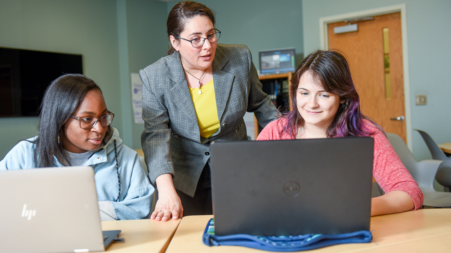 Melissa Pasquinelli with two students