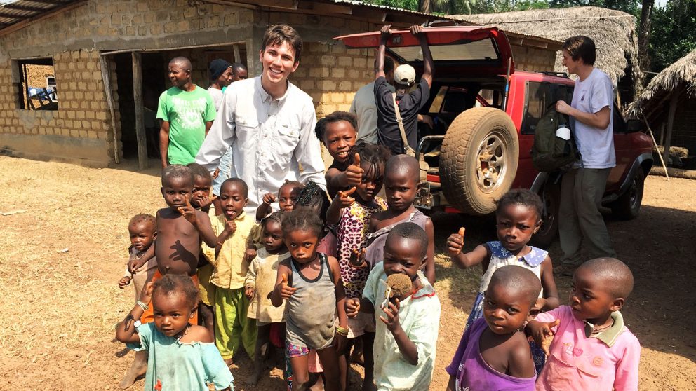 Member of NC State chapter of Engineers Without Border with children in Sierra Leone