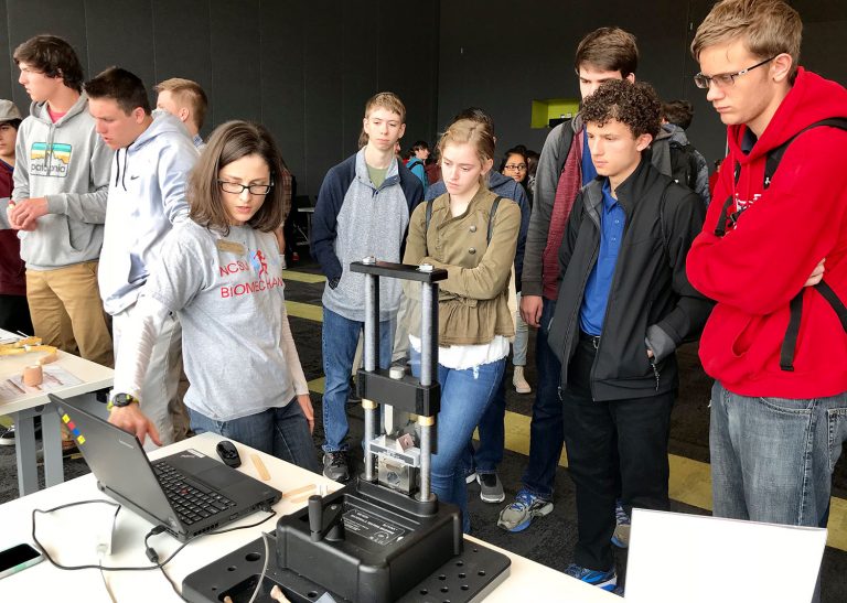 Students observe 3 pt bending process.