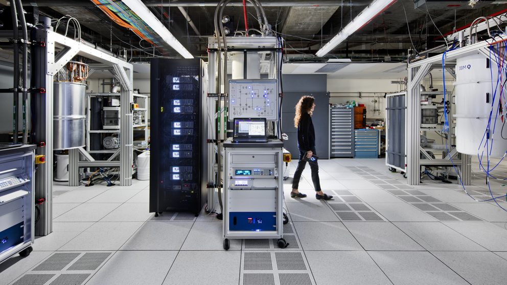 employee walking through a room with banks of computers