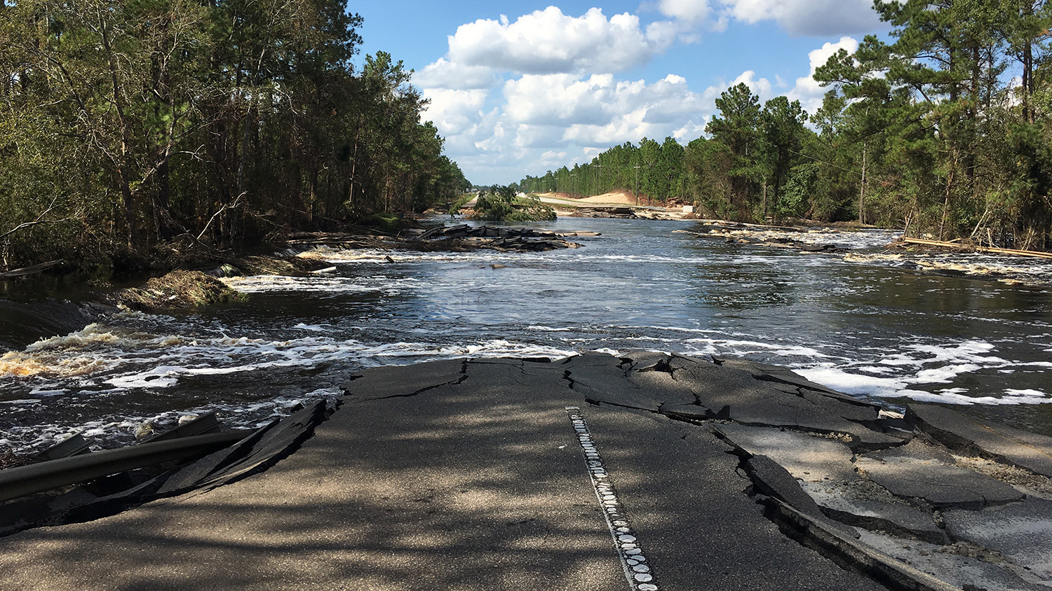 A cracked highway disappears into flood waters. (Photo: Brina Montoya)