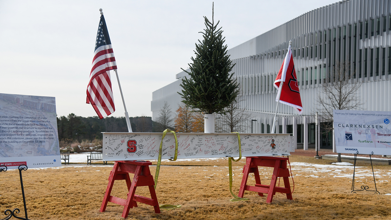 The high beam, which sits at the top of an elevator shaft in the building, was painted white. It was placed on two NC State red saddle horses on the morning of the 12th, and workers and NC State students, faculty and administrators were invited to sign it.