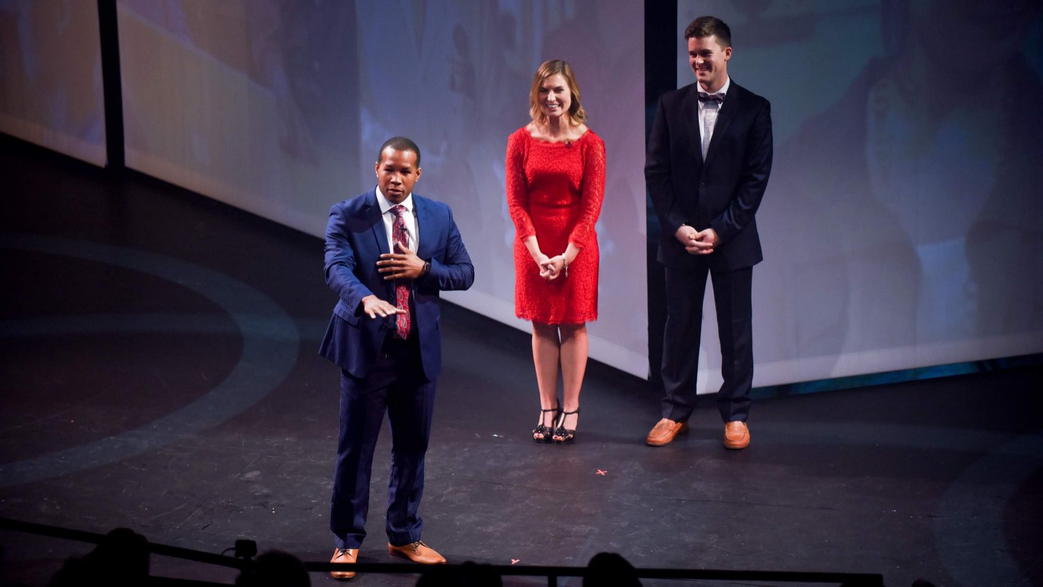 KeJuan Weaver (foreground), Hillary Spangler and Andrew Miller discuss the impact of philanthropy at Red and White Night 2018.