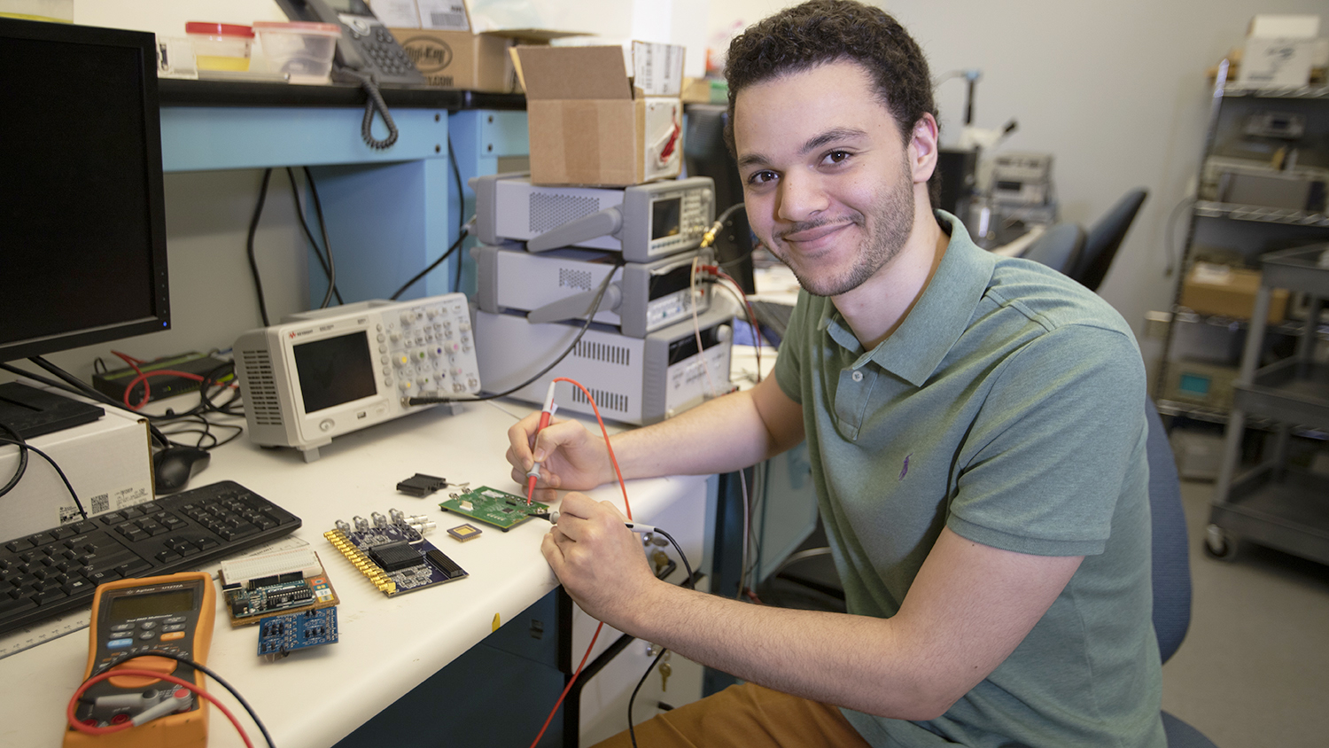 Ziad Ali works on a circuit in his lab.