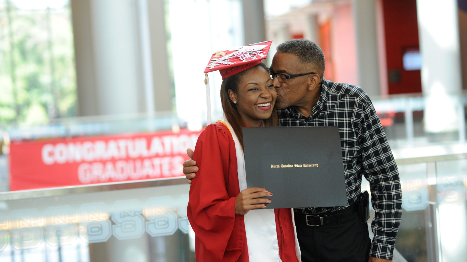 Departmental graduation ceremonies at Talley, 2016. Criminology grad Tatiana DeBerry is congratulated by family. Photo by Marc Hall