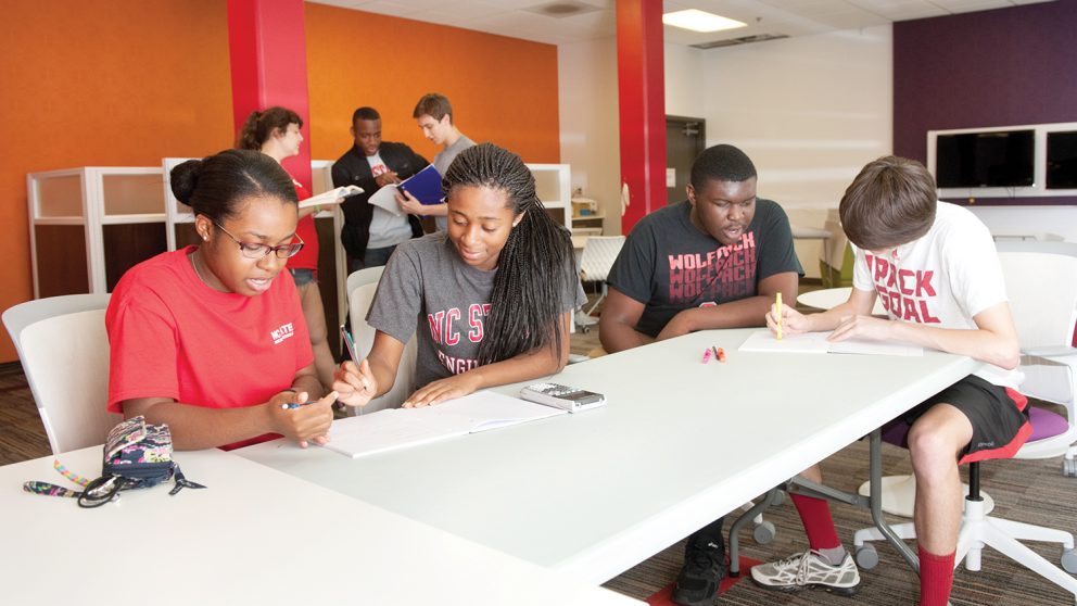 Four students working at table.