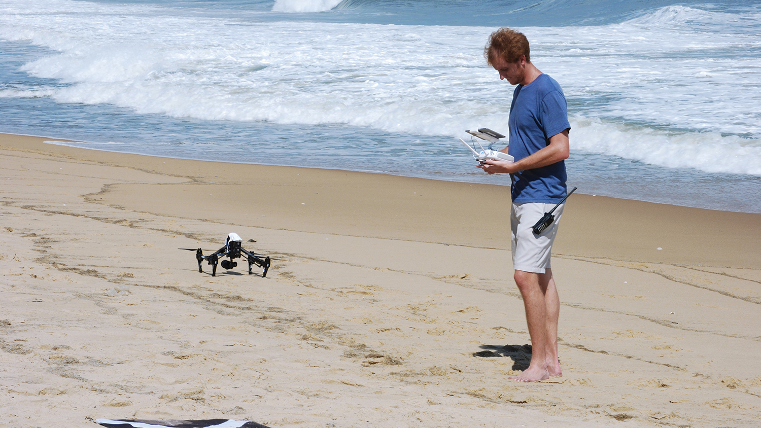 Member of the research team operates drone to evaluate the topographic surface and conduct geospatial analysis.
