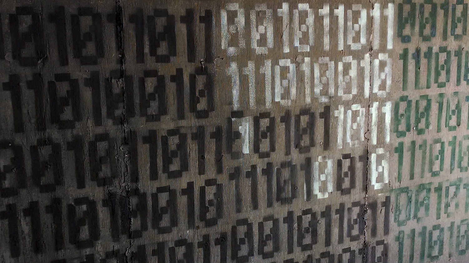 binary code spraypainted on wall