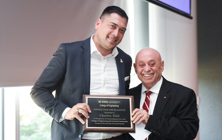 Dean Louis Martin-Vega presents Award for Excellence to Charles Hall.