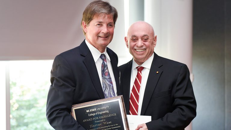 Dean Louis Martin-Vega presents Award for Excellence to Harvey West.