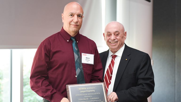 Dean Louis Martin-Vega presents Award for Excellence to Mitch Amiano.