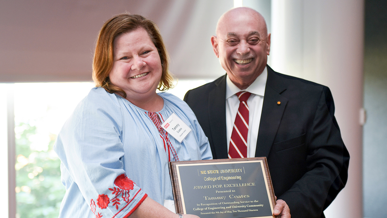 Dr. Louis Martin-Vega, dean of the College of Engineering, presents Award for Excellence to Tammy Coates.