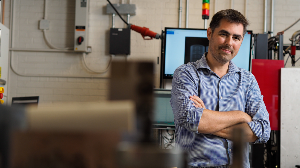 Tim Horn stands in the Center for Additive Manufacturing and Logistics