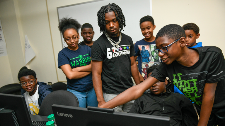 Counselors Kalyn Robertson and Nasir Jones answer campers' questions.