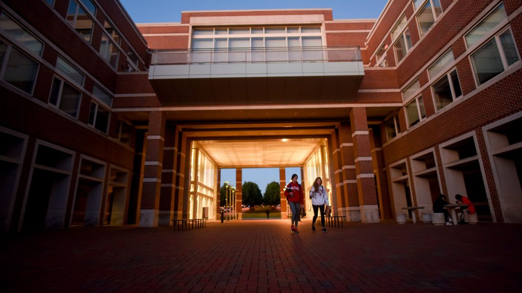 Two students exit EB II in the evening