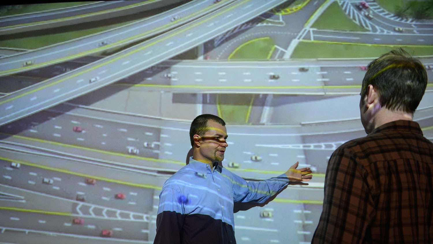 Dr. Bastian J. Schroeder, of the Institute for Transportation Research and Education (ITRE) at North Carolina State University, looks at a civil engineer project in the Teaching and visualization lab in the Hunt Library. Photo by Marc Hall