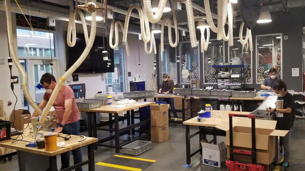 UNC students and makerspace staff volunteers process the materials used to make face shields