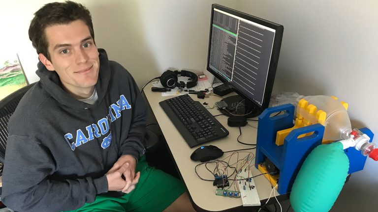 Biomedical engineering graduate student Thomas Kierski works with the emergency ventilator prototype (Photo by UNC-Chapel Hill)