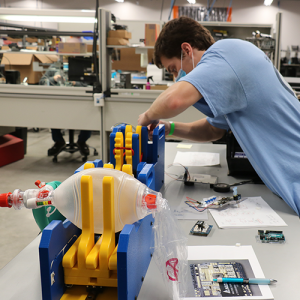 Biomedical engineering graduate student Thomas Kierski works on the ventilator prototype at the manufacturing facility of Toshiba Global Commerce Solutions in Research Triangle Park (Photo by Toshiba Global Commerce Solutions)