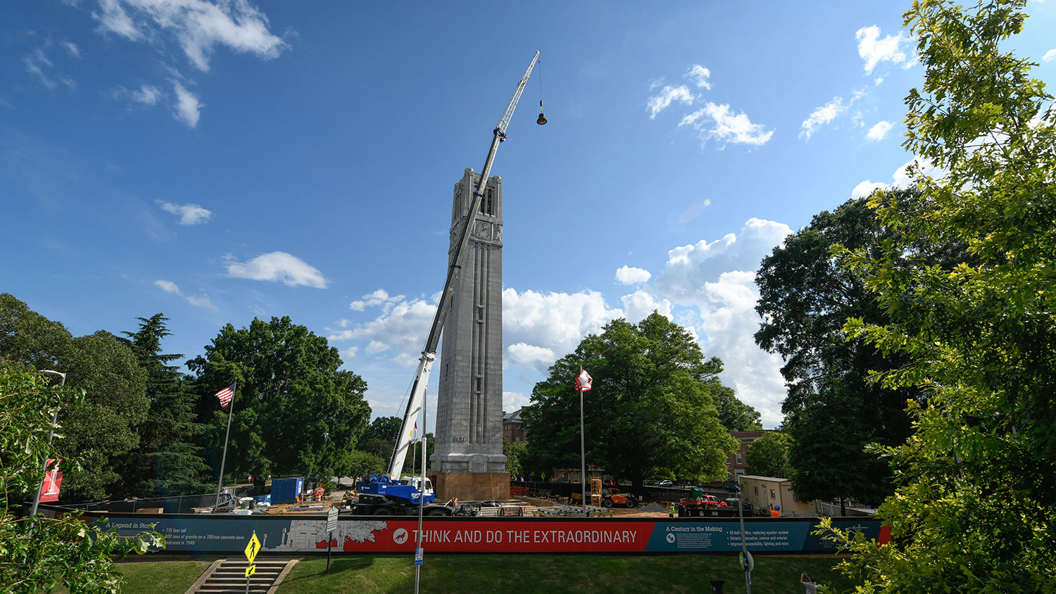 crane holding bell to be installed in the top of the belltower