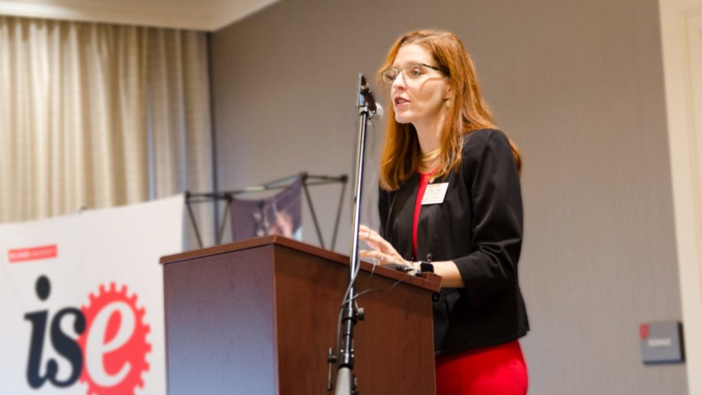 Julie Swann speaking at a podium