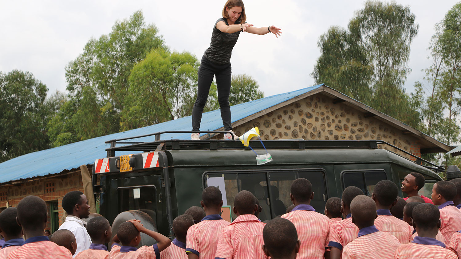 Tyler Brading tests parachutes by dropping them from top of jeep at Nkumba Primary School