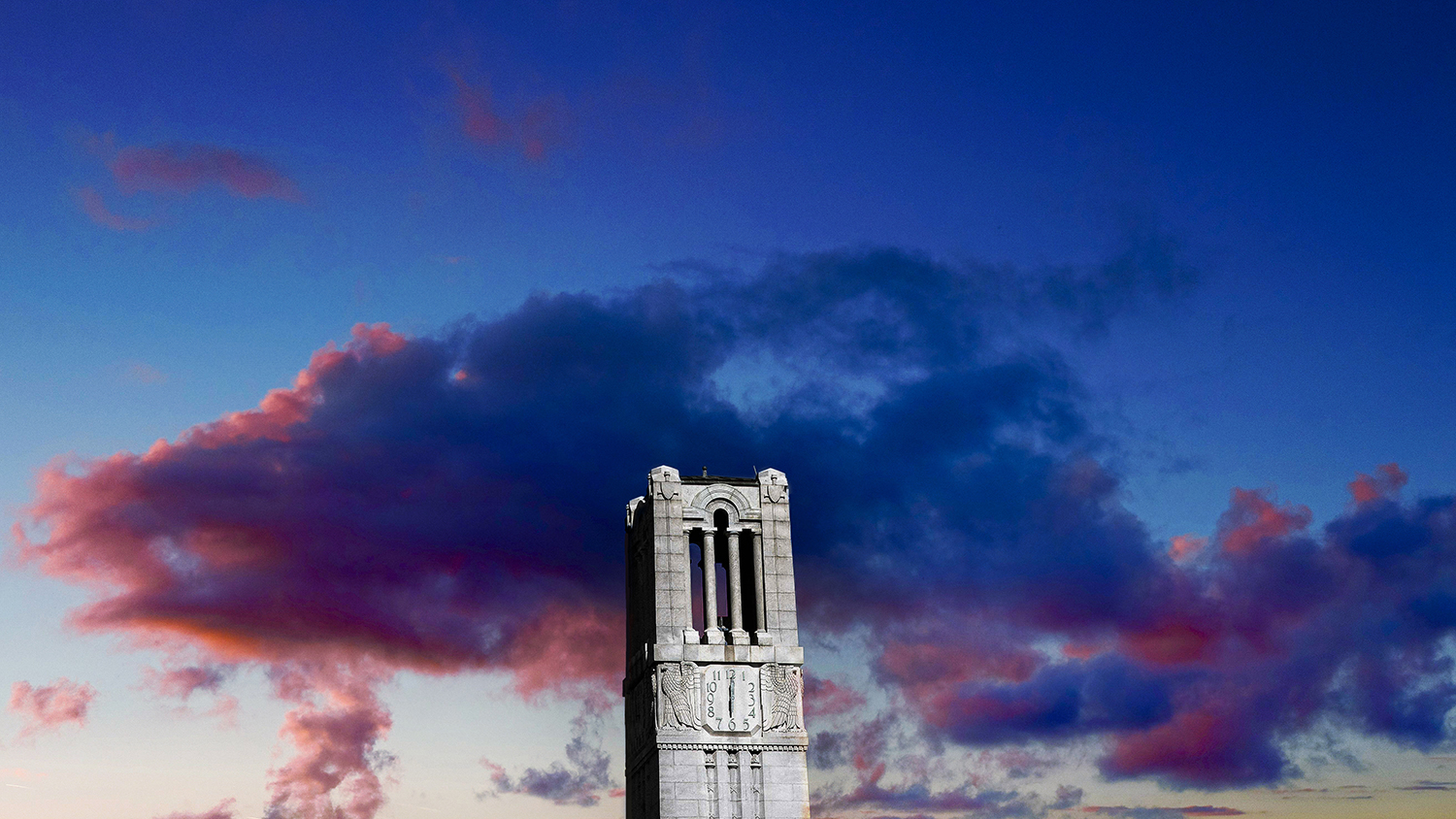 The Belltower against colorful clouds at sunset.