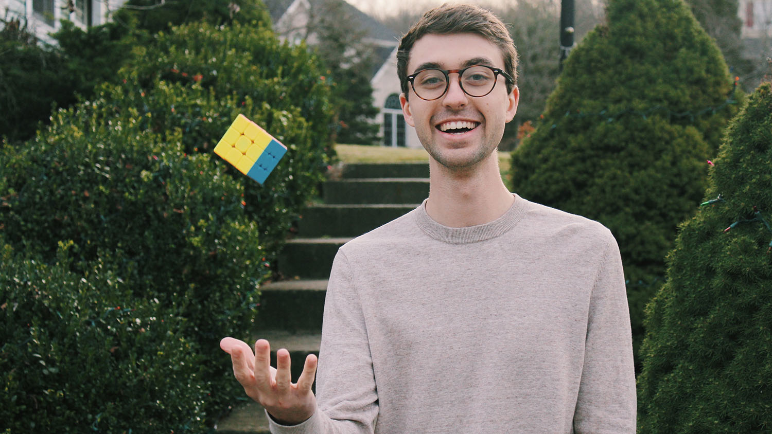 Colton Botta tosses a Rubik's cube into the air