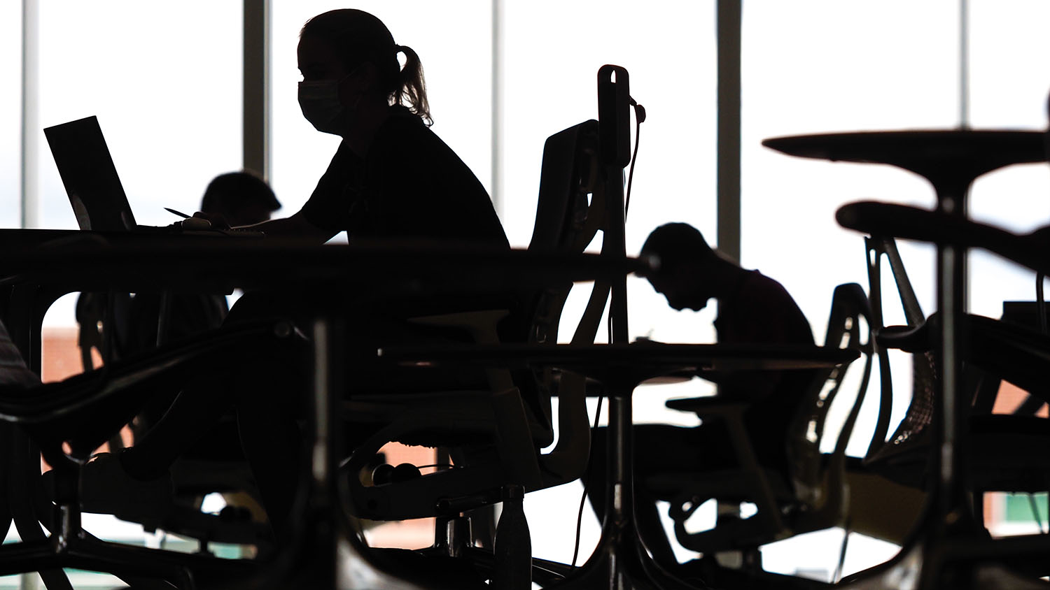 masked students in silhouette