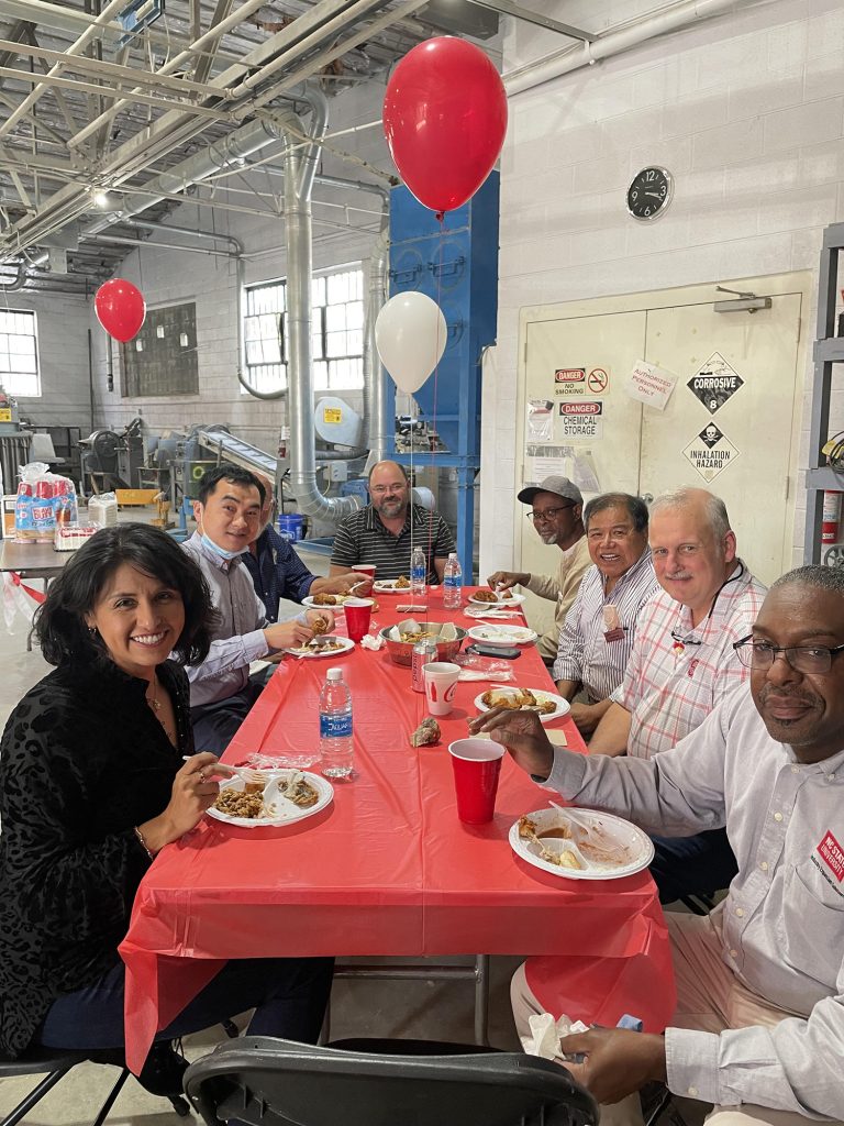 Minerals Research Lab staff sitting at a table enjoying a meal to celebrate the lab's 75th anniversary.