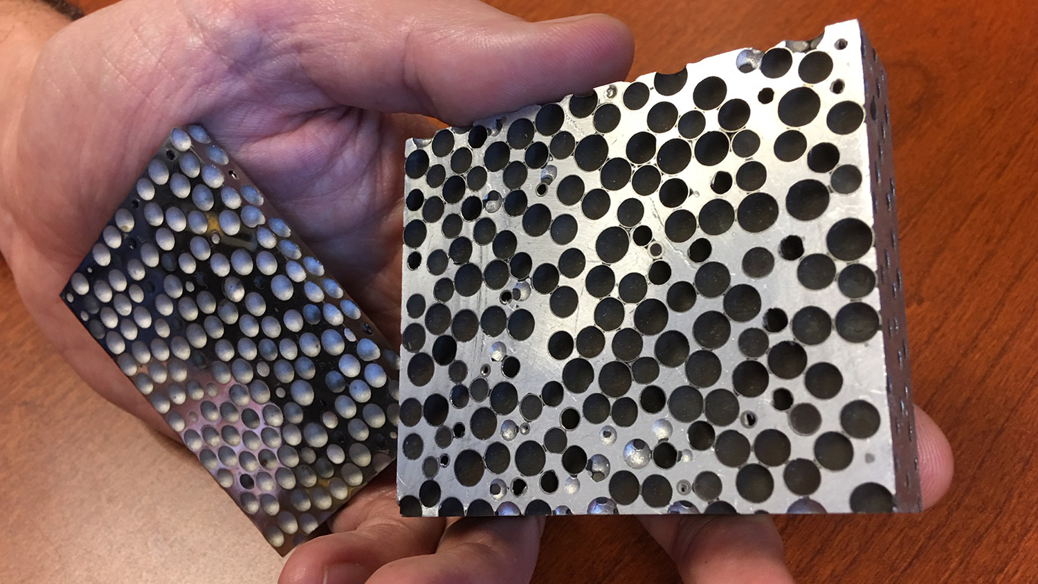 Closeup image of composite metal (silver with black dots).