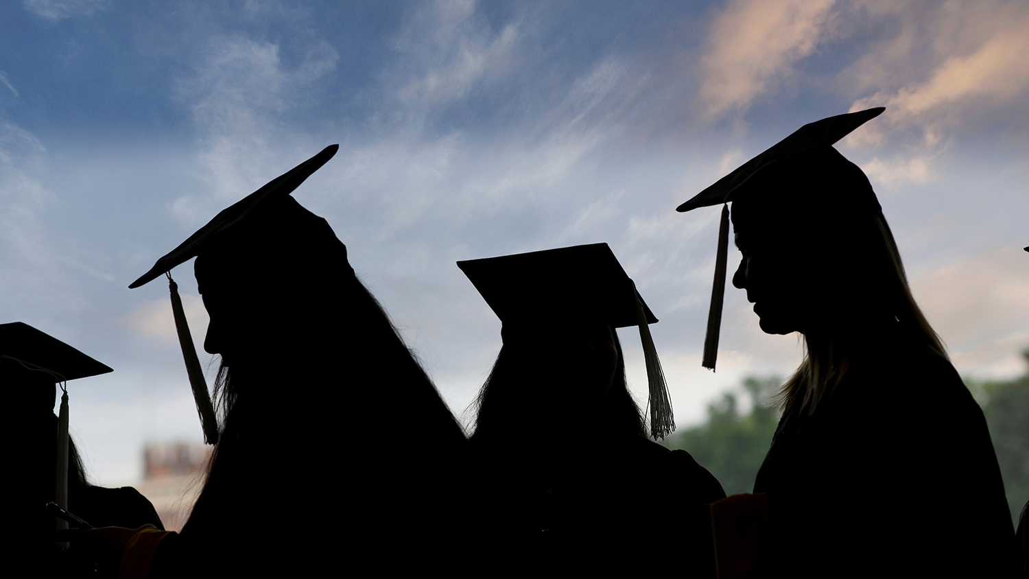 Graduating students in shadow profile.