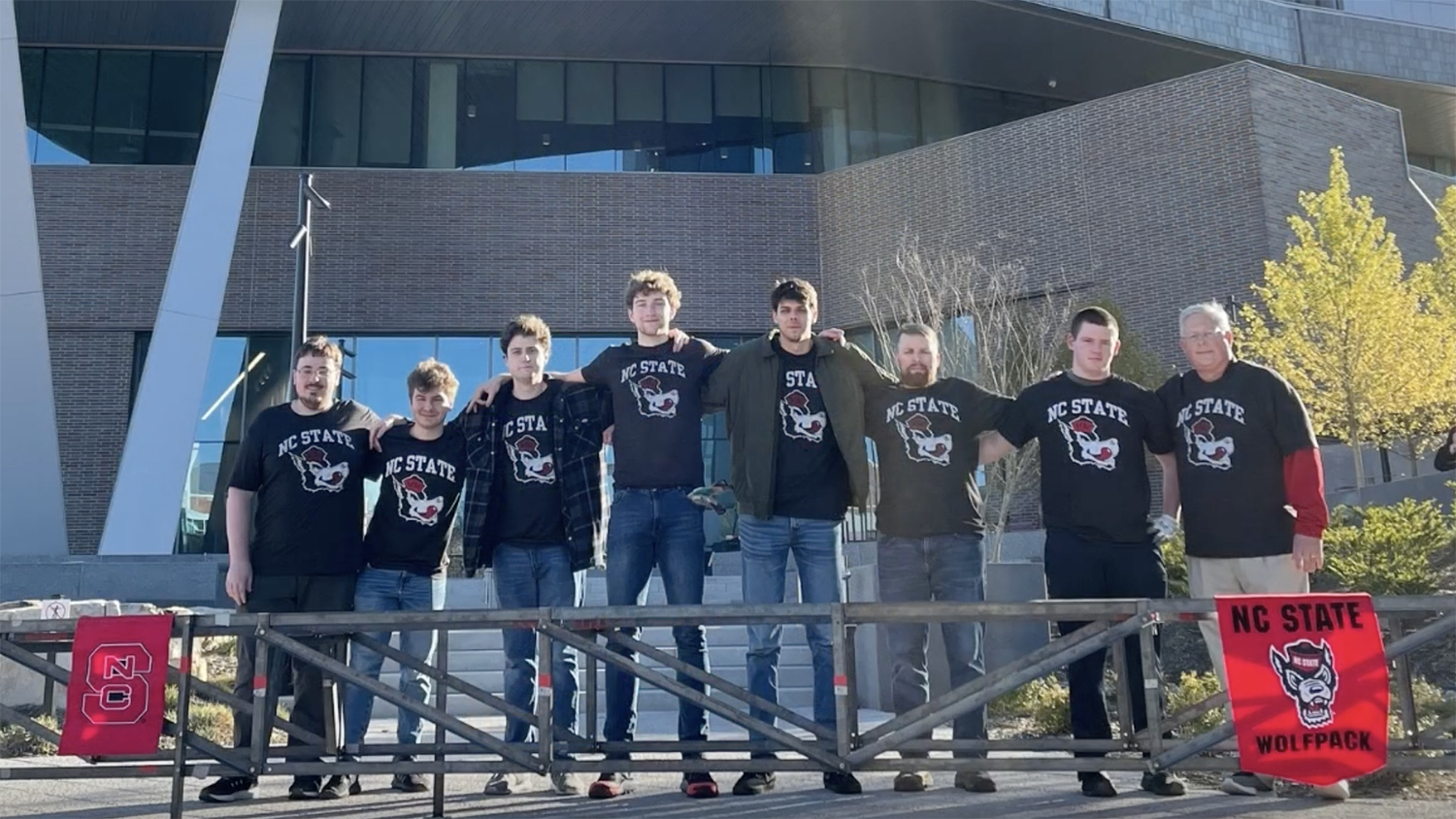 Steel bridge competition team stands together for a group photo in front of Fitts-Woolard Hall.