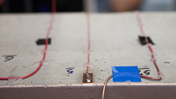 Closeup photo of electromagnetic sensors attached to concrete.