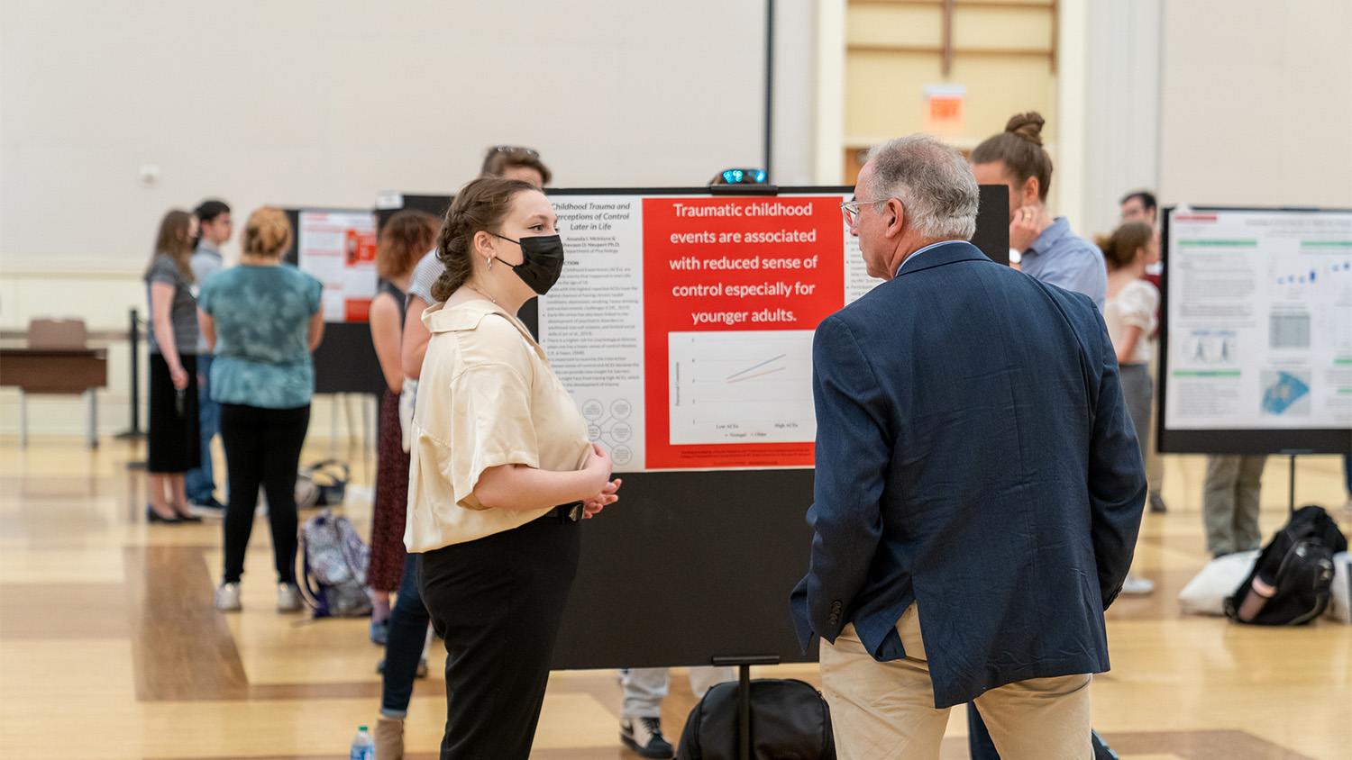 Spring Symposium attendees review and discuss projects.