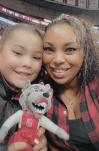 Candice Wallace, right, with one of her children and a stuffed Mrs. Wuf doll.