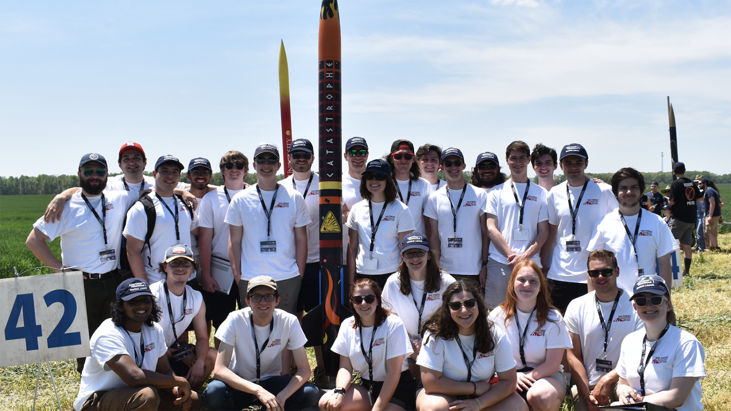 The 2021-2022 MAE rocketry team poses for a group photo with their model rockets.