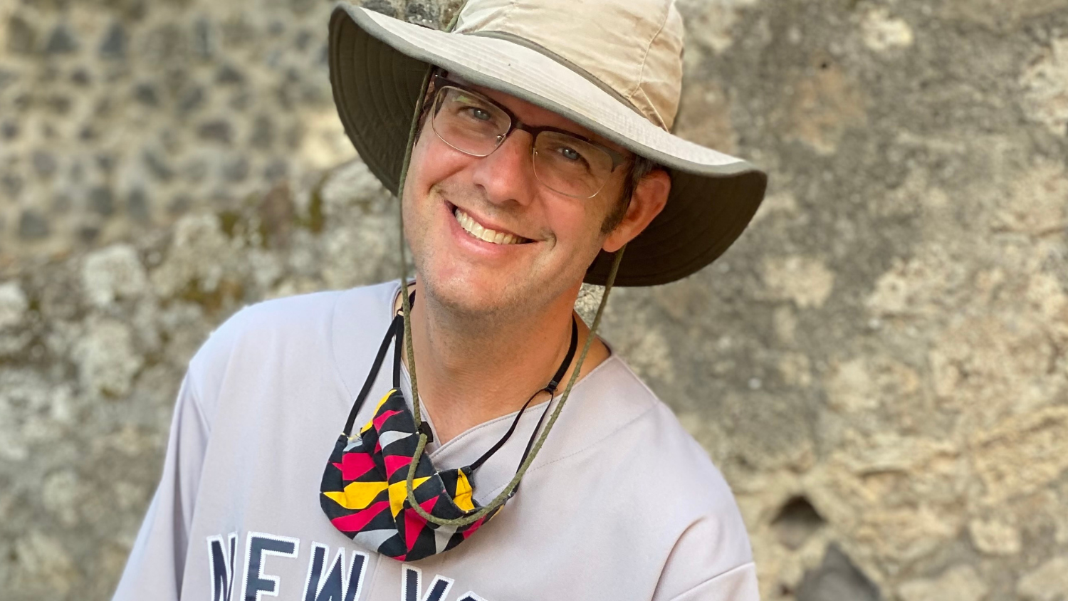 Bill Hunt outdoors wearing a brimmed hat and smiling.