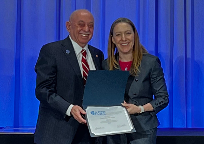 Louis Martin-Vega receives Fellow recognition from ASEE President Adrienne Minerick.